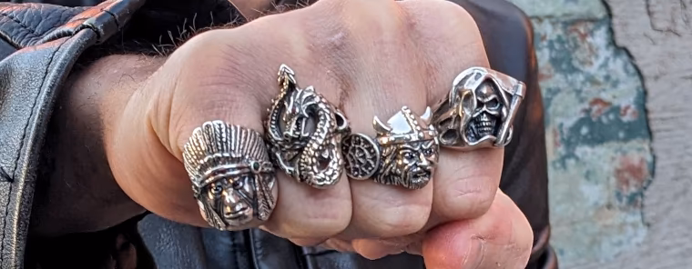 Character jewelry, silver Chief, Dragon, Viking, and Dragon rings on a man's hand
