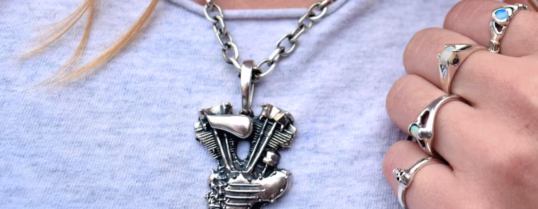 Classic silver heart, opal, skull rings on a lady's hand